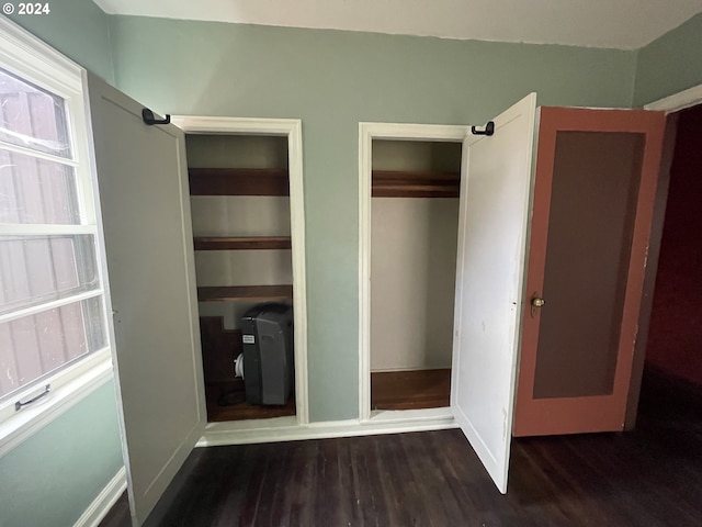 unfurnished bedroom featuring dark wood-type flooring