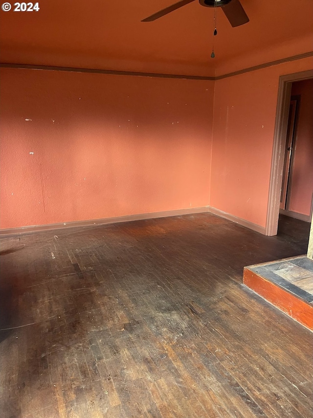 spare room featuring ceiling fan and dark hardwood / wood-style flooring