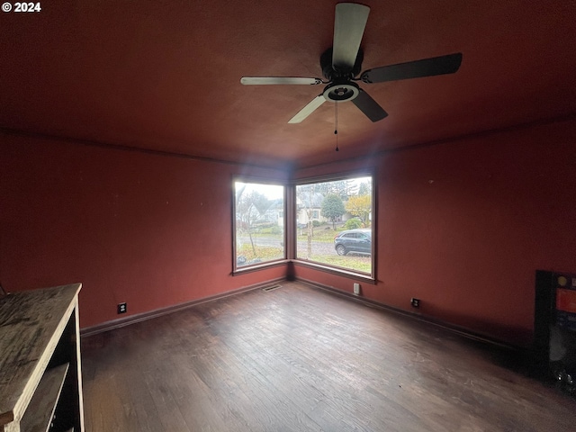 interior space with ceiling fan and dark wood-type flooring