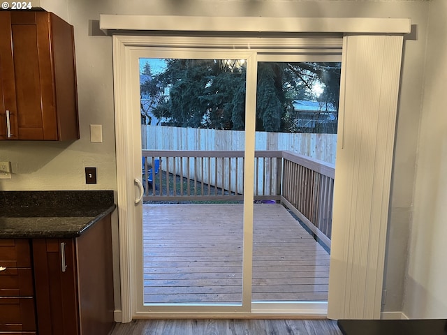 doorway with light wood-type flooring