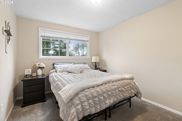 carpeted bedroom with a textured ceiling