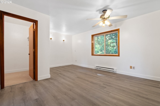 unfurnished room with baseboard heating, wood-type flooring, and ceiling fan