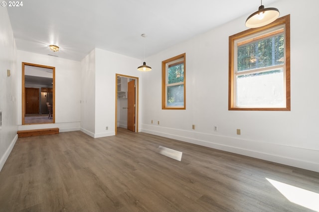 unfurnished room with dark hardwood / wood-style flooring