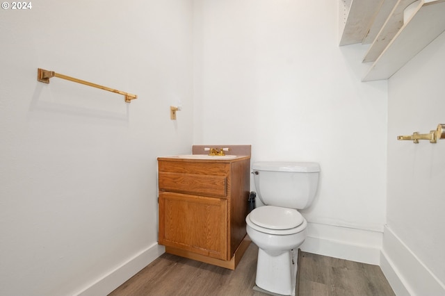 42 Fellers Rd, Carson, WA 98610 - half bathroom featuring toilet, wood finished floors, vanity, and baseboards