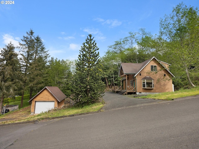 view of front of home featuring a garage and an outdoor structure