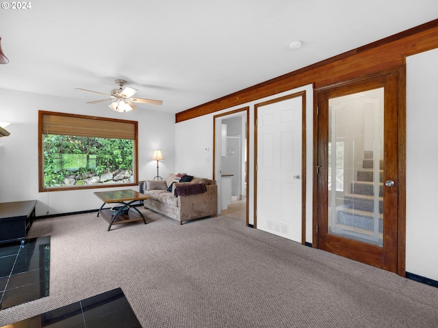 living room featuring carpet flooring and ceiling fan