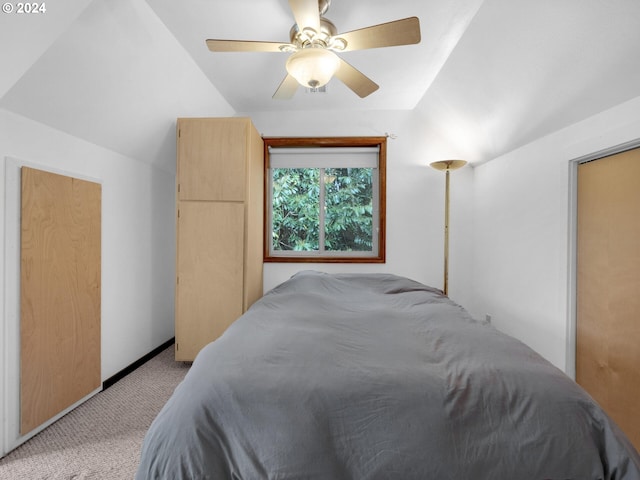 carpeted bedroom featuring vaulted ceiling and ceiling fan