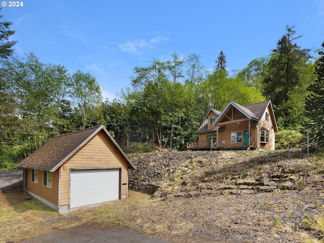 view of front of house featuring a garage and an outdoor structure