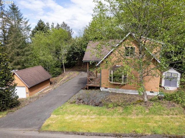 view of front of home with a garage and an outdoor structure