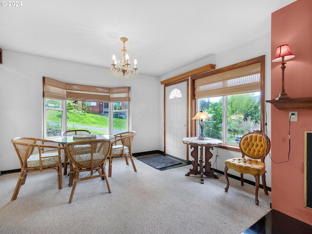 carpeted dining area featuring a chandelier and a wealth of natural light