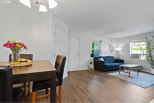 dining area featuring cooling unit and hardwood / wood-style flooring