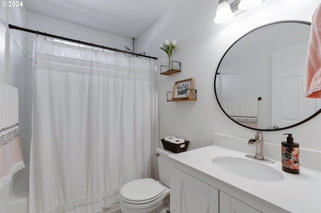 bathroom featuring vanity, toilet, and walk in shower