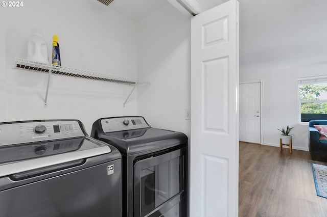 laundry room featuring hardwood / wood-style flooring and independent washer and dryer