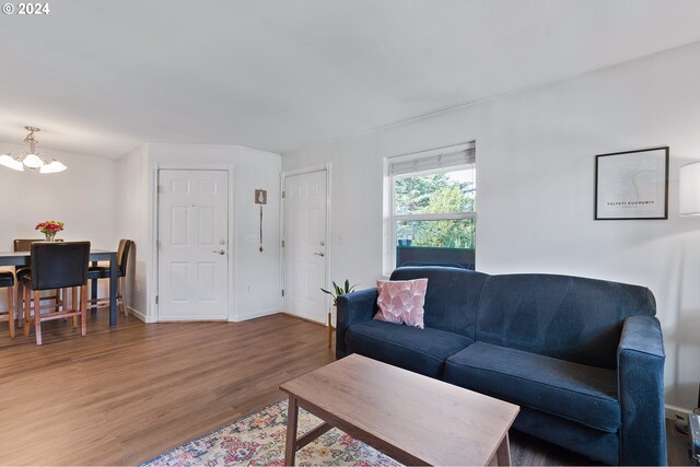 living room featuring a chandelier and dark hardwood / wood-style flooring