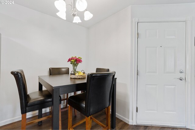 dining room featuring dark hardwood / wood-style floors and a notable chandelier