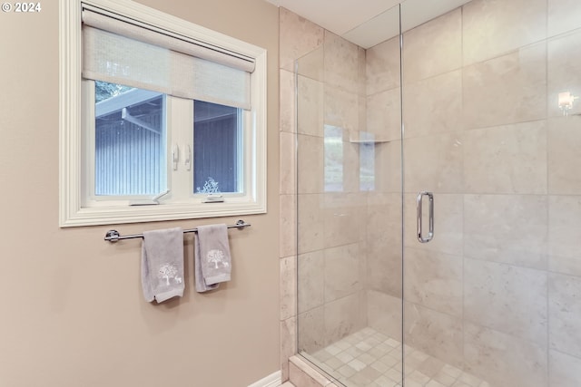 bathroom featuring a shower with shower door