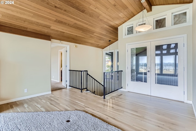 entrance foyer featuring french doors, vaulted ceiling with beams, wood ceiling, and hardwood / wood-style floors