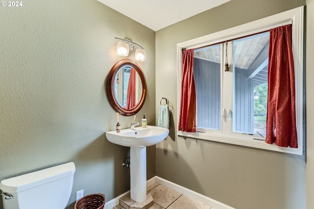 bathroom with tile patterned flooring and toilet