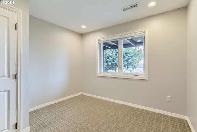 unfurnished room with light colored carpet