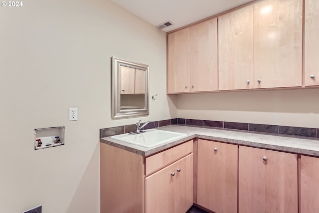 laundry room with cabinets, washer hookup, and sink