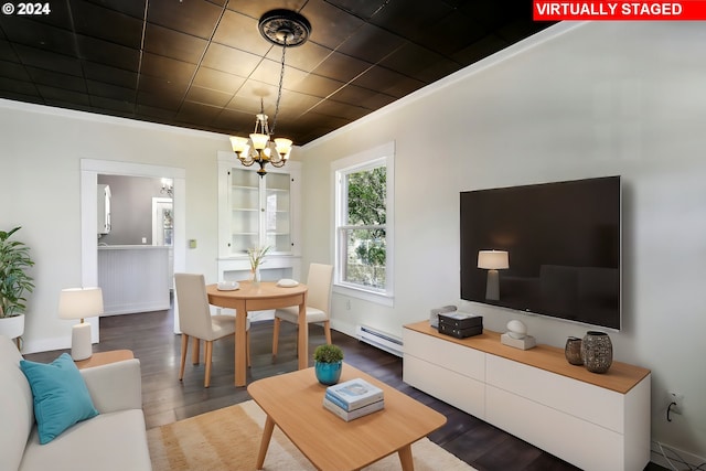 living room with ornamental molding, baseboard heating, a chandelier, and dark hardwood / wood-style flooring