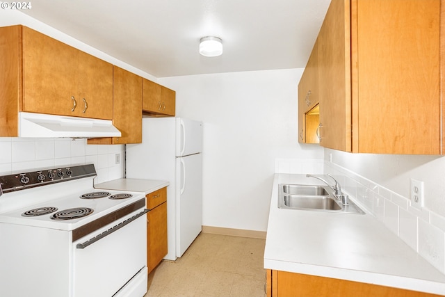 kitchen with under cabinet range hood, white appliances, a sink, light countertops, and brown cabinets