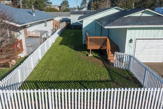 exterior space with a garage and a lawn