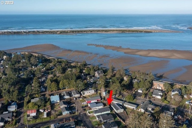 drone / aerial view featuring a water view and a view of the beach