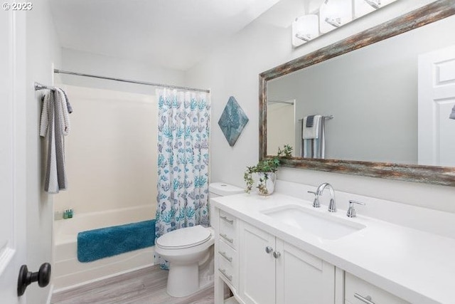 full bathroom with wood-type flooring, vanity, toilet, and shower / bath combo