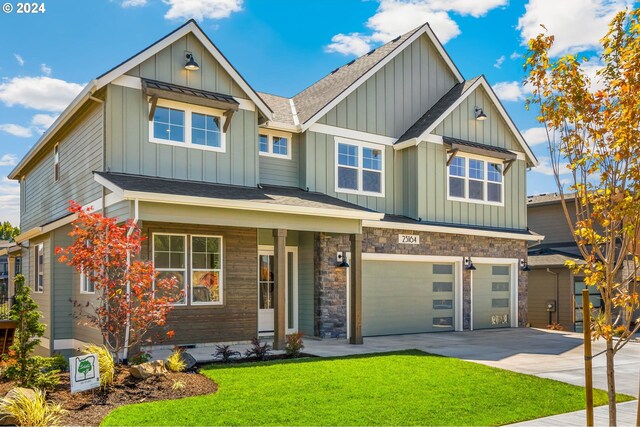 craftsman house with a garage and a front lawn