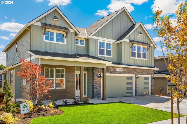 craftsman-style home featuring driveway, a front lawn, a garage, stone siding, and board and batten siding