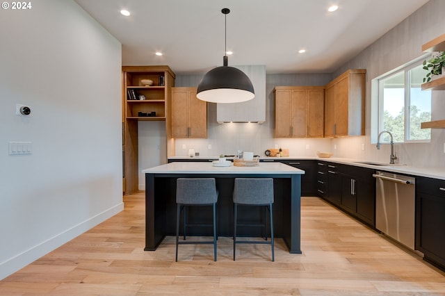 kitchen featuring open shelves, a kitchen island, dishwasher, light countertops, and a sink