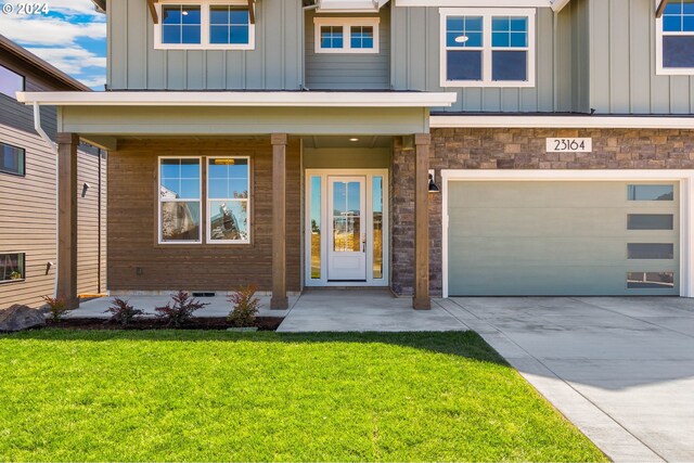 craftsman house with a front lawn and a garage