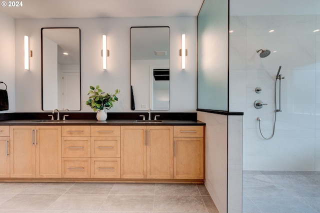 bathroom featuring double vanity, walk in shower, and a sink