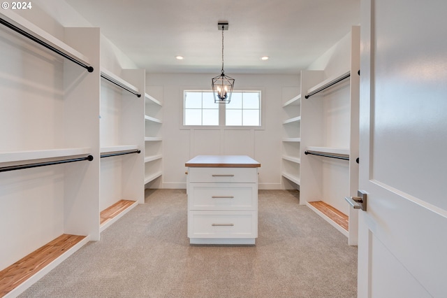 walk in closet featuring light colored carpet