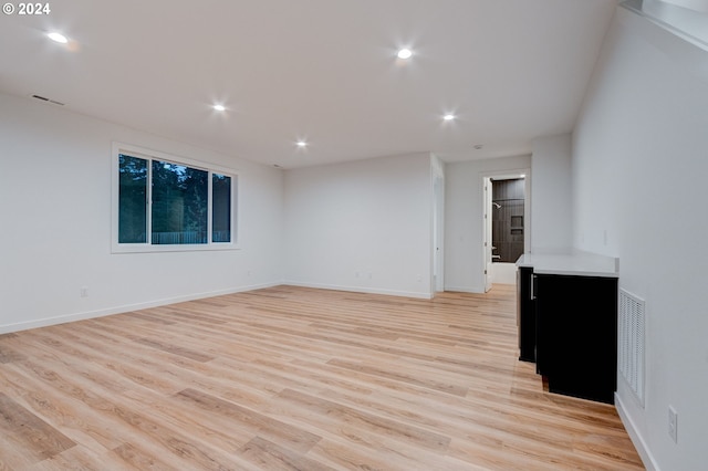 unfurnished room featuring recessed lighting, light wood-type flooring, baseboards, and visible vents