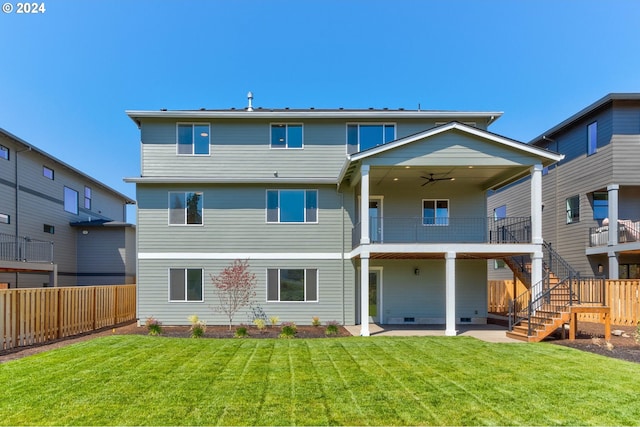 back of house with a lawn, a ceiling fan, fence, stairway, and a patio area