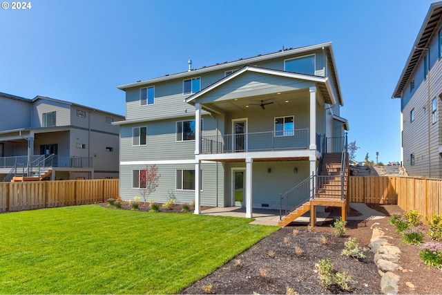 rear view of property featuring ceiling fan, stairs, a yard, a fenced backyard, and a patio