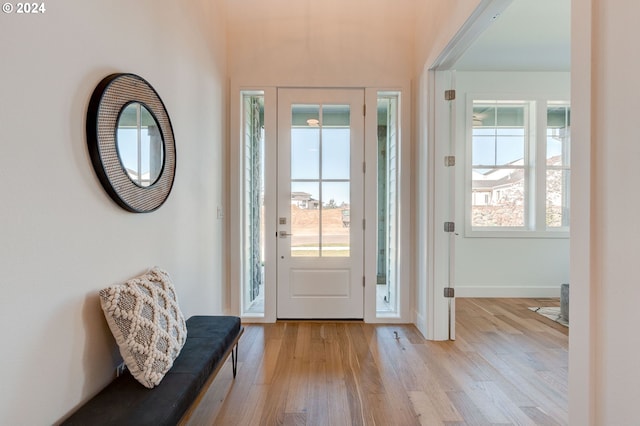 entryway with light wood-style floors and baseboards