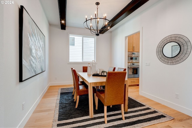 dining space featuring beamed ceiling, light wood-style floors, baseboards, and a chandelier