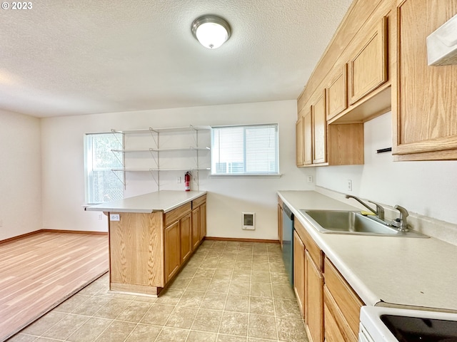 kitchen with a breakfast bar area, a textured ceiling, a wealth of natural light, and light tile floors