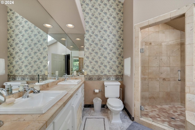 bathroom with a shower with door, vanity, and toilet