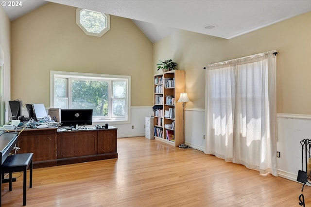 office area featuring high vaulted ceiling and light wood-type flooring