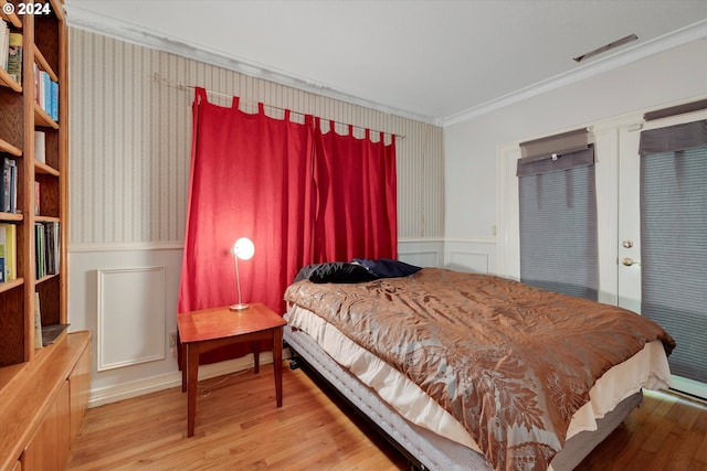 bedroom featuring wood-type flooring and crown molding