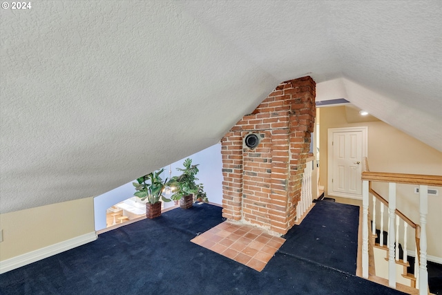 bonus room with vaulted ceiling, carpet flooring, and a textured ceiling