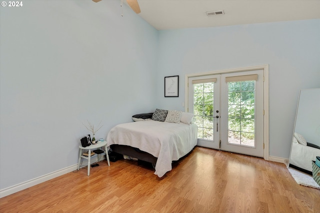 bedroom featuring french doors, access to exterior, ceiling fan, and light hardwood / wood-style flooring