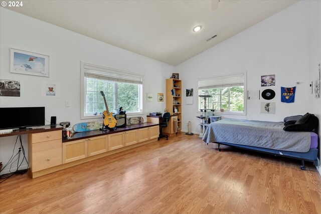 bedroom featuring high vaulted ceiling and light hardwood / wood-style floors