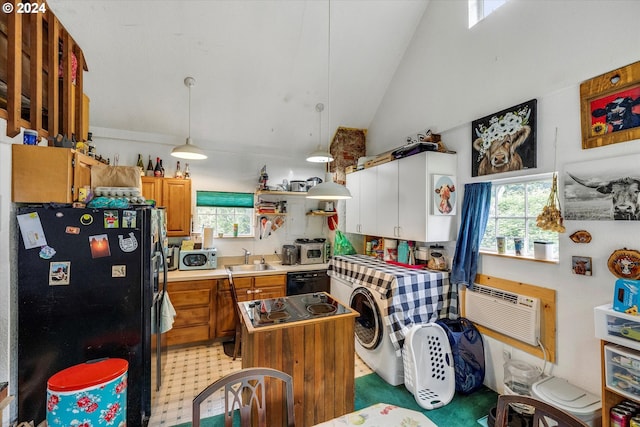 kitchen with high vaulted ceiling, decorative light fixtures, sink, a center island, and black appliances