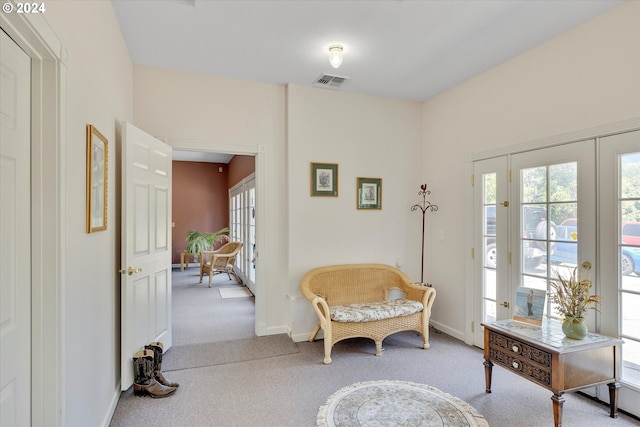 living area with light colored carpet and french doors