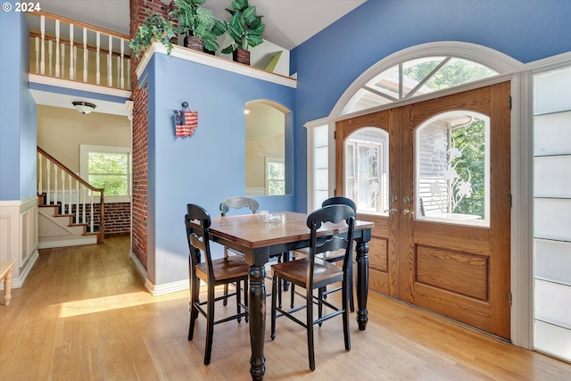 dining room featuring french doors and light wood-type flooring